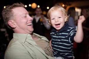 Ian, held by dad, boogieing on the dance floor
